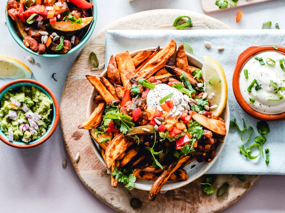 Loaded sweet potato fries topped with salsa, cheese, and sour cream.